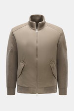 Front view of Moose Knuckles Down blouson 'Magnus Knit Hybrid' taupe, featuring high-quality microfiber, wool knitted sleeves, soft touch, slim fit, durable two-way zipper, high ribbed collar, metal logo on upper arm, hip pockets with flap, light down fil