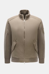 Front view of Moose Knuckles Down blouson 'Magnus Knit Hybrid' taupe, featuring high-quality microfiber, wool knitted sleeves, soft touch, slim fit, durable two-way zipper, high ribbed collar, metal logo on upper arm, hip pockets with flap, light down fil