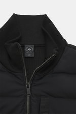 Close-up front view of the Moose Knuckles Down Blouson 'Kamet Hybrid' black, made of viscose and microfiber, knitted back and sleeves, soft touch, slim fit, robust two-way zipper, high closing ribbed collar, typical metal logo on the upper arm, slanted hi