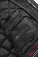 Close-up inside view of Moose Knuckles Leather blouson 'Toba Bomber' black showing quilted lining, leather trim, and brand label.