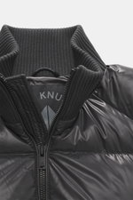 Close-up front view of Moose Knuckles Down blouson "King's Puffer" grey, featuring high-quality microfiber, slim fit, warm down filling, two-way zipper, typical blouson collar made of ribbed knit, front pockets with snap button, rubberized label on upper 