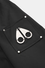 Close-up side view of the Moose Knuckles Jacket 'Jacques' black, featuring high-quality microfiber, smooth feel, slim fit, robust two-way zipper, turn-down collar, patch chest pockets with flap, slanted welt pockets, metal logo on upper arm, cuff sleeves 