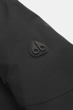 Close-up view of the Moose Knuckles Down jacket 'West-Ed 3Q' black showing the high-quality microfiber fabric with smooth touch and the black metal logo on the raglan sleeve, featuring wind- and water-repellent material, warm down filling, regular fit, tw