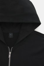 Close-up front view of the black Moose Knuckles Sweat jacket 'Hartsfield Zip-Up' showing lined hood, robust two-way zip, wide ribbed bands, sweat made of pure cotton, soft feel, slim fit, integrated hip pockets, and patch with signature metal emblem on sl