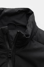 Close-up front view of the black Canada Goose Daunenweste 'Lodge' with a padded stand-up collar and robust two-way zipper, featuring ripstop microfiber fabric, smooth feel, wind- and water-resistant, lightweight down fill, slim fit, tonal web label, side 
