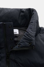 Close-up front view of the collar and zipper of the Stone Island Daunenweste 'Seamless Tunnel Nylon Down' navy, made from smooth, elastic microfiber with wind- and water-resistant, PFC-free finish.
