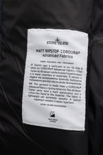 Close-up view of the inner label on the Stone Island Daunenweste 'Seamless Tunnel Nylon Down' navy, showcasing fabric details and anti-drop finish.