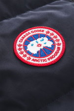 Nahaufnahme des Weblabels auf der Brust der Canada Goose Daunenweste 'Legacy Freestyle' dark navy, strapazierfähige Microfaser, wind- und wasserabweisend.