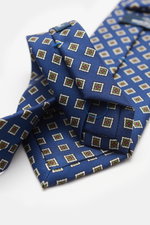 Close-up view from above of Bigi Seidenkrawatte 'Nilo' blau/oliv/weiß gemustert, a pure silk tie with subtle shine, classic diamond pattern, matching lining, 8 cm wide, Made in Italy.