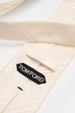 Close-up top view of Tom Ford Silk tie cream/white striped showing fine weave pattern, subtle sheen, and branded lining.

Italian craftmanship: This classic tie by TOM FORD in pure silk combines timeless elegance with a fine, graphic weave pattern and add