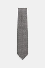 Top-down view of Tom Ford Silk tie dark navy/white patterned with fine weave, subtle sheen, pure silk, branded lining, 8 cm wide, made in Italy.