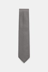 Top-down view of Tom Ford Silk tie dark navy/white patterned with fine weave, subtle sheen, pure silk, branded lining, 8 cm wide, made in Italy.