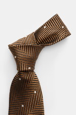 Close-up top view of Tom Ford Silk tie light brown/black/cream patterned with herringbone and polka dots, pure silk with subtle sheen.

Description: 
<p>Confident elegance down to the finest detail: This fine silk tie by TOM FORD is a stylish essential fo