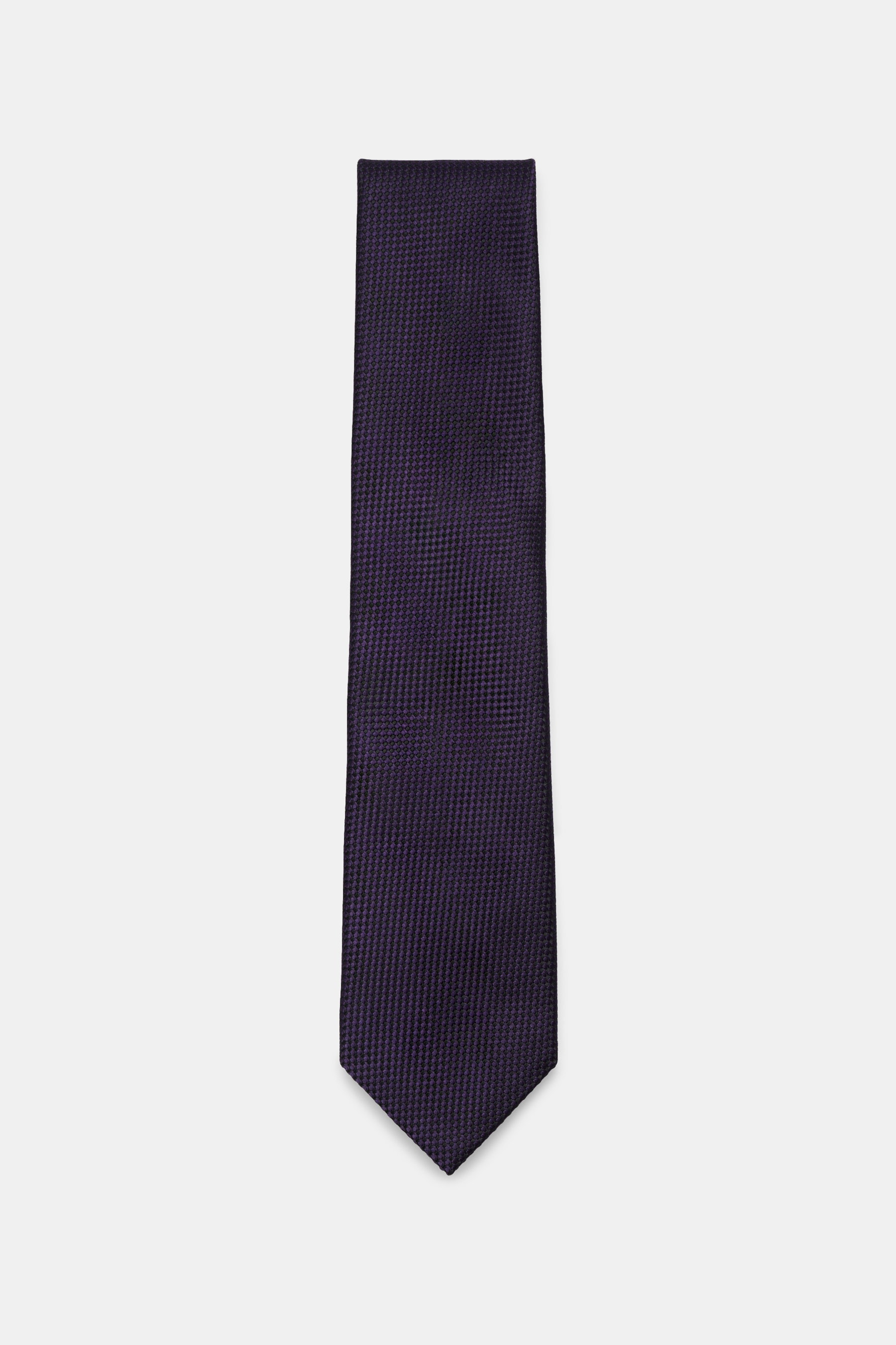 Tom Ford Silk tie dark violet/black patterned, photographed top-down, showcases pure silk with subtle shine, timeless houndstooth, logo stitching, made in Italy, width 8 cm. Luxurious sophistication: The silk tie by TOM FORD sets an elegant accent for for