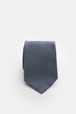 Tom Ford Seidenkrawatte navy/creme gemustert, fotografiert von oben, reine Seide, dezenter Glanz, grafisches Muster, Logo-Stitching, made in Italy, 8 cm breit.