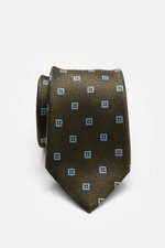 Zegna Silk tie smoky blue/navy patterned rolled up, front view showing pure silk, subtle shine, graphic woven pattern, contrasting lining, Made in Italy, width approx. 8 cm.
