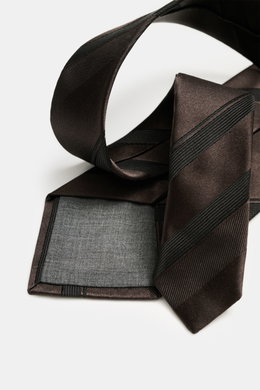 Brunello Cucinelli Silk tie dark brown/black striped, photographed from a close-up side angle, showing pure silk with subtle shine, stylish diagonal stripes, Made in Italy, width approx. 8 cm.