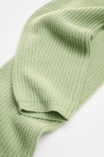 Close-up top-down view of the Lisa Yang Cashmere scarf 'Marseille' light green showing its voluminous ribbed texture and open rib knit cuffs.

<p>A luxurious accessory: The scarf 'Marseille' in voluminous cashmere from Swedish label LISA YANG has a distin