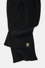 Close-up top-down view of the Belstaff Scarf 'Watch' black showing its wide rib knit pattern, soft pure wool texture, and typical BELSTAFF label.

Additional description:
<p>The cozy 'Watch' scarf by BELSTAFF made of pure wool with a modern rib knit look 