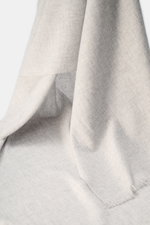 andrea's 1947 Cashmere scarf light grey melange shown from a close-up perspective, highlighting pure cashmere, very soft touch, fine lightweight quality, narrow fringed edge, dimensions approx. 198 cm x 62 cm