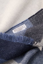 Close-up shot of the Brunello Cucinelli Scarf light grey/grey blue/navy checked, showing fabric texture and label, blend of wool and cashmere, smooth touch, large checked pattern, narrow fringed hem, dimensions approx. 162 cm x 47 cm.