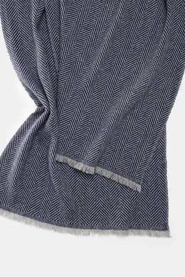 Close-up front view of the Brunello Cucinelli Cashmere scarf grey/dark blue patterned, showing its classic herringbone weave and fringed edge.

<p>Quiet-luxury label BRUNELLO CUCINELLI is known for its elegant, timeless cashmere creations – like this two-