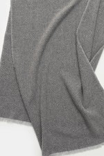 Close-up top-down view of the Brunello Cucinelli Cashmere Scarf grey/light grey patterned showing its classic herringbone woven design and narrow fringed edge.

Additional description:  
<p>Quiet-luxury label BRUNELLO CUCINELLI is known for its elegant, t
