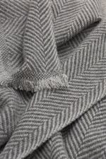 Close-up top-down view of the Brunello Cucinelli Cashmere Scarf grey/light grey patterned showing the classic herringbone weave and narrow fringed edge.

<p>Quiet-luxury label BRUNELLO CUCINELLI is known for its elegant, timeless cashmere creations - like