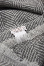 Close-up top-down view of the Brunello Cucinelli Cashmere Scarf grey/light grey patterned showing its classic herringbone weave and label.