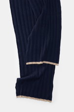 Close-up top-down view of the Brunello Cucinelli Cashmere Scarf navy showing its pure cashmere ribbed knit and label.  
<p>Elegant through the winter with BRUNELLO CUCINELLI: This scarf made of pure cashmere in a distinctive ribbed knit design not only pr