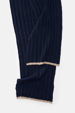 Close-up top-down view of the Brunello Cucinelli Cashmere Scarf navy showing its pure cashmere ribbed knit and label.  
<p>Elegant through the winter with BRUNELLO CUCINELLI: This scarf made of pure cashmere in a distinctive ribbed knit design not only pr