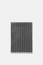 Brunello Cucinelli Cashmere Scarf dark grey, folded flat, ribbed knit pattern, soft pure cashmere, photographed from above.