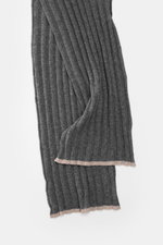 Close-up side view of the Brunello Cucinelli Cashmere Scarf dark grey showing label and ribbed knit texture. Elegant through the winter with BRUNELLO CUCINELLI: This scarf made of pure cashmere in a distinctive ribbed knit design not only provides warmth 