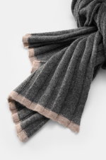 Close-up front view of the Brunello Cucinelli Cashmere Scarf dark grey, showing its classic ribbed knit design and soft texture. Elegant through the winter with BRUNELLO CUCINELLI: This scarf made of pure cashmere in a distinctive ribbed knit design not o