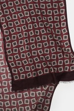 Altea Scarf dark violet/burgundy/dark grey patterned shown from above, featuring a graphic print with rolled edges, narrow fringed hem, smooth texture, mix of wool and modal, lightweight quality, dimensions approx. 182 cm x 53 cm.
