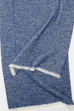 Close-up top view of the 04651/ A trip in a bag Scarf 'Fancy Twill' dark blue/cream showing a coarse twill structure, narrow fringed edge, soft feel, made of a mix of virgin wool, baby alpaca, and high-quality microfiber, dimensions approx. 180 cm x 48 cm