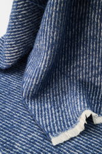 Close-up front view of the 04651/ A trip in a bag Scarf 'Fancy Twill' dark blue/cream showing coarse twill structure, narrow fringed edge, soft feel, made of virgin wool, baby alpaca, and microfiber, dimensions approx. 180 cm x 48 cm.