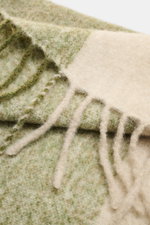 Close-up from above of the 04651/ A trip in a bag Scarf 'Color Block Scarf' green melange/beige/cream showing soft fringed hem and color block design.

<p>Essential winter must-have: The elegant scarf by 04651/ A TRIP IN A BAG becomes a favorite piece for