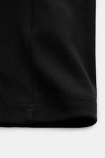 Close-up view of the hem of the Tom Ford V-Neck Unterhemd navy, showing jersey cotton fabric with comfortable stretch, very soft feel, extra slim fit, V-neck, and a small woven label at the hem.