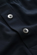 Close-up angled view of the side button fly on the Stefan Brandt Boxershorts 'Bari' navy, showcasing smooth, soft navy fabric with two silver buttons engraved with the brand name. <p>Komfort im Alltag: Die Boxershorts von STEFAN BRANDT aus weicher Baumwol