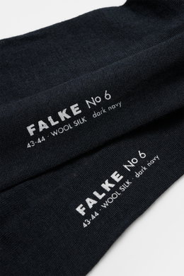 Falke Sock 'No. 6' dark navy shown from a close-up angled top view, highlighting fine knit texture and white logo print. With the 'No. 6' sock, FALKE shows how luxurious comfort can be: The finest Australian merino wool meets elegant mulberry silk to crea
