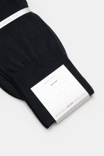 Falke Sock 'No. 6' dark navy folded on a white surface, photographed from above showing fine knit and packaging label. With the 'No. 6' sock, FALKE shows how luxurious comfort can be: The finest Australian merino wool meets elegant mulberry silk to create