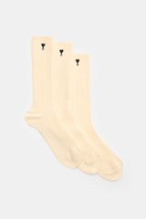 Ami Paris Socks pack of 3 pairs cream shown from a top-down perspective, featuring rib knit texture and signature heart stitching.