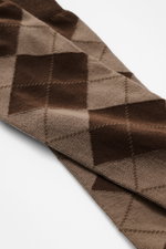 Close-up angled view of MC2 Saint Barth Knee-high socks 'Sox' dark brown patterned, showing classic argyle pattern with mix of cotton and microfibre, slightly elastic quality, reinforced heel and toe, comfortably wide cuff, and tonal branding.