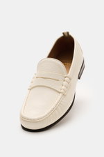 Officine Creative Penny Loafer 'Balfron' creme shown from a slightly elevated front angle, crafted from smooth deer leather with a narrow silhouette, typical penny strap, decorative seam on the toe cap, leather lining, and leather sole, a stylish and dura