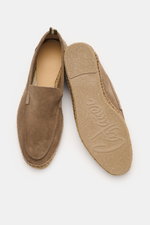 Top-down view of Castañer Espadrilles 'Nino T' taupe in soft suede, showing one shoe’s upper with a slightly tapered cut and decorative toe seam, and the other shoe’s sole featuring braided jute edging and flexible natural rubber sole with logo. Summery l