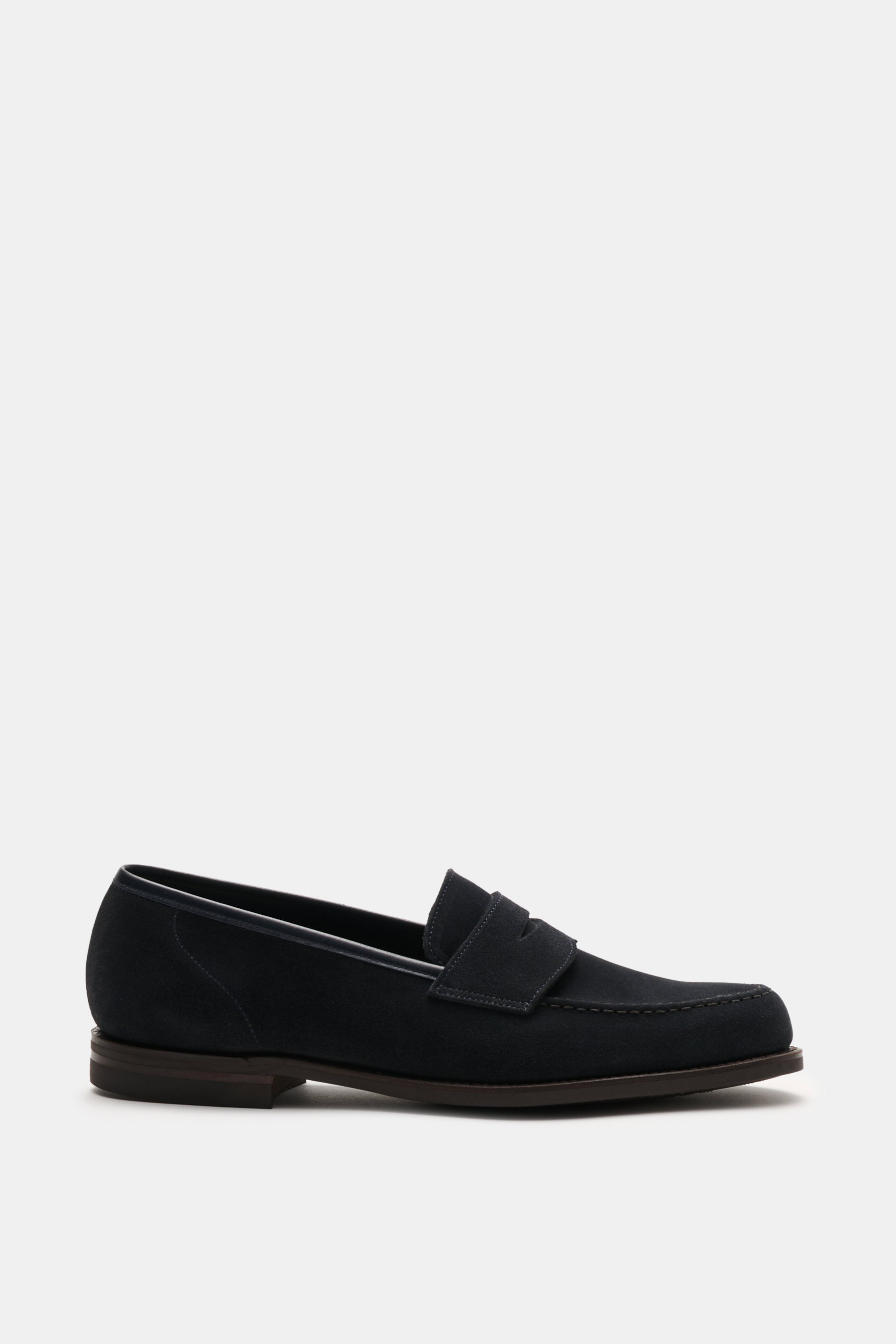 Side view of a Crockett & Jones Penny Loafer 'Harvard' navy in elegant navy blue suede with water-repellent finish and rubber sole, smooth velour leather, narrow silhouette, typical penny strap, front cap stitching, and stitched sole construction.