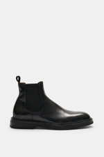 Side view of Officine Creative Chelsea Boot 'Dude Flexi' black in polished smooth leather, Goodyear welted with tapered silhouette and elastic inserts.