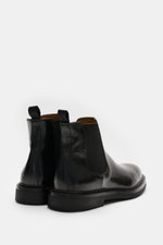 Rear-side view of Officine Creative Chelsea Boot 'Dude Flexi' black in polished leather with pull tabs, elastic inserts, and welted sole.