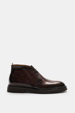 Side view of Officine Creative Chelsea Boot 'Dude Flexi' black in polished smooth leather with Goodyear welted sole, tapered silhouette, elastic inserts, pull tab, leather lining, and natural rubber outsole, combining artisanal precision and modern comfor
